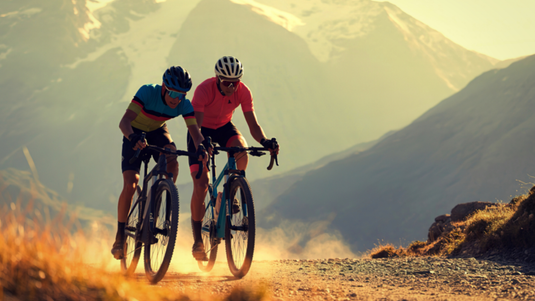 Gravel Bike Cyclists Riding On Mountain Trail
